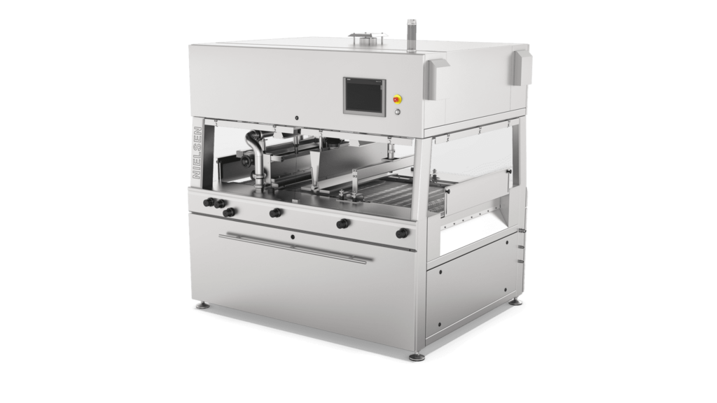 Aasted Nielsen Master Enrober, engineered for precision chocolate coating, ensuring seamless enrobing of confectionery products with a consistent and high-quality finish